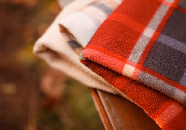 Close-up shot of warm blankets on a bench